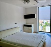 Bedroom in a 2-room apartment with a bed and a nightstand, floor with wood decor.