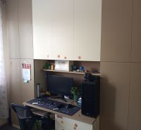 A work corner with an office chair, computer, and storage cabinets in a 3-room apartment.