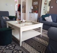 Living room in a 3-room apartment with a comfortable sofa and a patterned carpet.