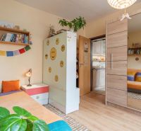 Children's room with a mirrored wardrobe, cheerful decorations, and a wooden-patterned floor.