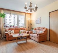 Living room in a 3-room apartment with sofas and a wooden decor floor.