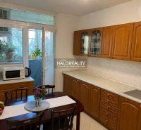 A kitchen in a 3-room apartment with wooden cabinets and access to a balcony.