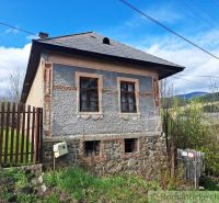 A unique property in the village of Heľpa with an older stone foundation and a colorful facade.