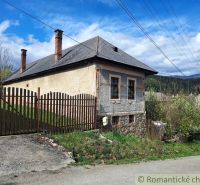 An old building with a sloped roof and a fence in Heľpa, Unusual properties.