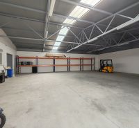 Warehouse and hall space with high ceilings and shelves, suitable for storage and logistics.