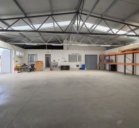 Interior with storage shelves, a motorcycle, and a workbench, Warehouses and halls.