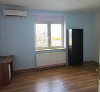 A room in a family house with a wooden decor floor and furniture.
