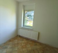 A room in a family house with light ceramic tiles and white walls.