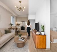 Interior of a 2-room apartment with a wooden decor floor, kitchen, and living room.