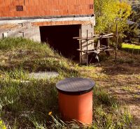 Unbuilt land near a cottage in the Recreational Area in Nova Kelca with growing grasses.