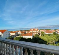 View from a holiday apartment in the town of Brač over the rooftops and the sea.