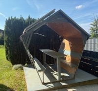 The cottage in Ilava has a wooden shelter with benches and a table in the garden.