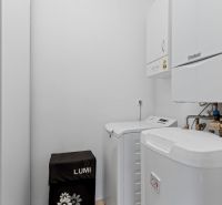 A technical room with a boiler and a washing machine in a 2-room apartment.