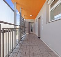 A hallway with an orange ceiling and railing, 2-room apartment.