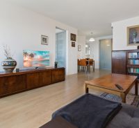 Living room with a sofa set, a table, and a wooden decor floor in a 2-room apartment.