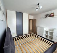Bedroom in a 3-room apartment with a bed and a built-in wardrobe.