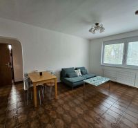 Living room in a 3-room apartment with tiles, a light sofa, and a table.
