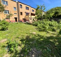 A garden at a family house on Hurbanova Street in Trenčín with a well-maintained lawn and shrubs.