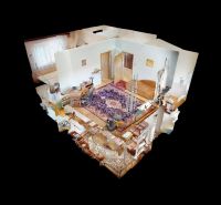 Interior of a family house with carpet and wood-patterned flooring.