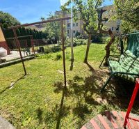 The garden of a family house on Hurbanova Street in Trenčín with a garden swing.