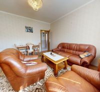 The family house offers a living room with leather sofas and wooden floor decor.