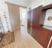 A library with decorations and sliding doors in a family house with a wooden decor floor.