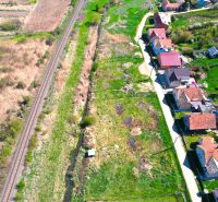 Railway track and houses lining the road in Hodejov, plots - living in a green environment.