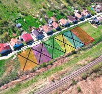 Aerial view of residential plots in Hodejov, houses, and a railway track.