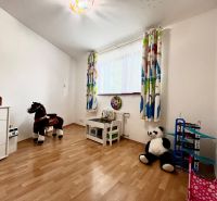 A children's room with toys and a wooden decor floor in a 3-room apartment.