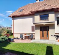 A family house with a terrace and a garden in Martin, surrounded by greenery and shrubs.