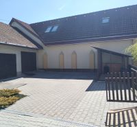 A family house in Martin with a garage and a paved courtyard.