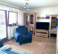 Living room in a family house with a comfortable armchair and a wooden decor floor.