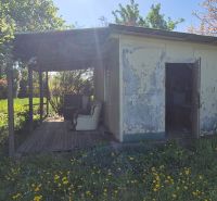 An older garden cottage surrounded by flowers on Vodná Street in Nitra.