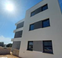A recreational apartment in Novalja, a three-story building, sunny day, blue sky.