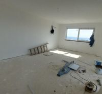 A recreational apartment under construction, with a sea view, containing tools and materials.