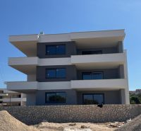 Construction of a recreational apartment in Novalja with a three-story structure and a stone fence.