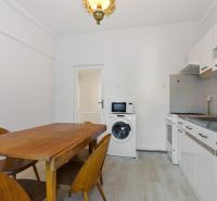 Kitchen in a 3-room apartment with a dining table and kitchen unit.