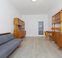 Interior of a 3-room apartment with retro furniture and wooden decor flooring.