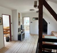 Interior of a family house with a wooden decor floor and a staircase.