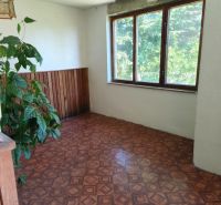A room in a family house with a window and a wooden decor floor.