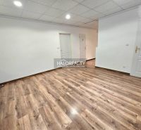 Spacious room with wooden decor flooring and shelves in a 3-room apartment.