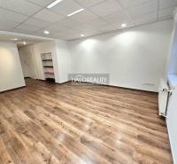 A room in a 3-bedroom apartment with a wooden-patterned floor and white walls.