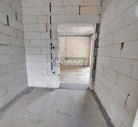 Empty room in a family house with unfinished walls and floor.
