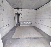 Empty room with unplastered walls in a family house, concrete floor surface.