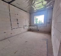 A room in a family house with raw walls, ready for completion.