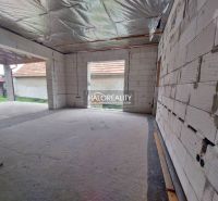 An unfinished interior of a family house with unbuilt walls and open spaces.