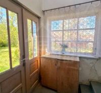 Entrance area of the family house with a wooden cabinet and beautiful glazing.