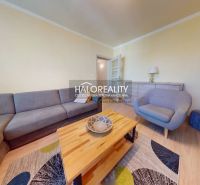 Living room in a two-room apartment with a large sofa and a coffee table.