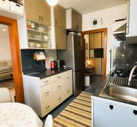 Kitchen with dining table, view into the living room, 3-room apartment.