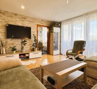 Living room in a 3-room apartment with light flooring and stylish furniture.